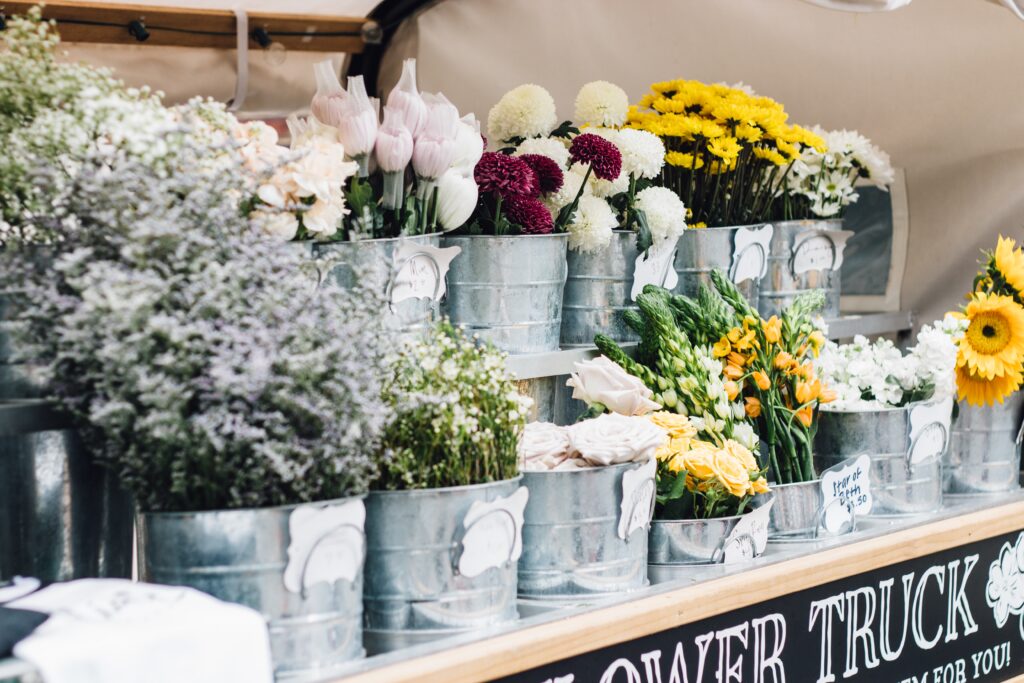 Fresh flowers in galvanized buckets on a flower truck

