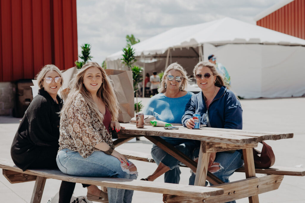 Four women enjoy outdoor food trucks at The City Mercantile 
